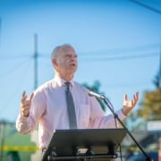 Paul Savas speaks at podium during event in Gladstone