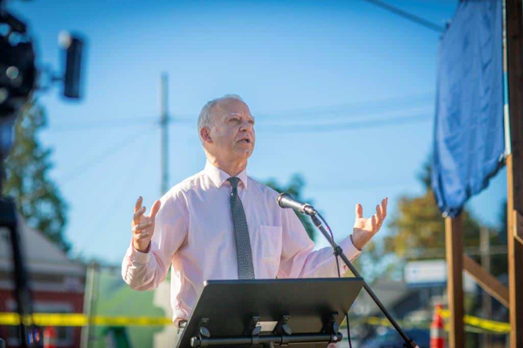 Paul Savas speaks at podium during event in Gladstone